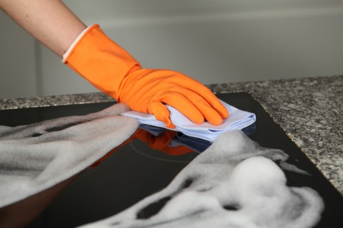 Cleaning professional reviewing safety procedures with protective equipment nearby